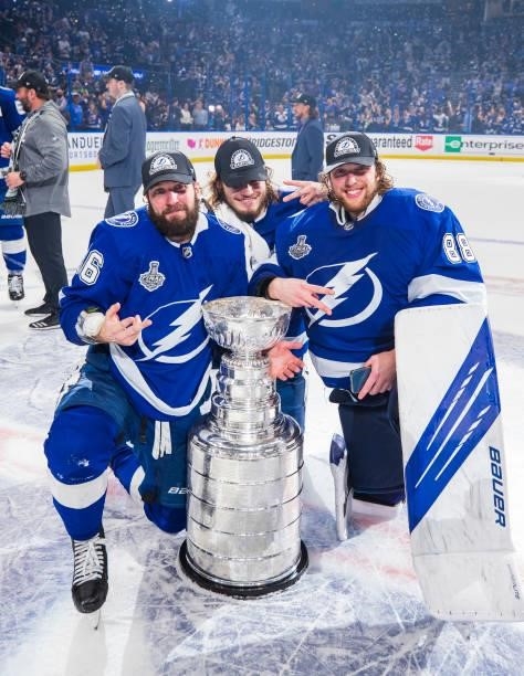 Nikita Kucherov, Mikhail Sergachev, and goalie Andrei Vasilevskiy of the Tampa Bay Lightning celebrates with the Stanley Cup after defeating the...