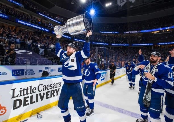 Steven Stamkos and Victor Hedman of the Tampa Bay Lightning hoists the Stanley Cup overhead after the Tampa Bay Lightning defeated the Montreal...