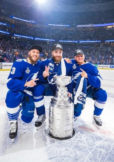 Fredrik Claesson, Victor Hedman, and Andreas Borgman of the Tampa Bay Lightning celebrates with the Stanley Cup after defeating the Montreal...