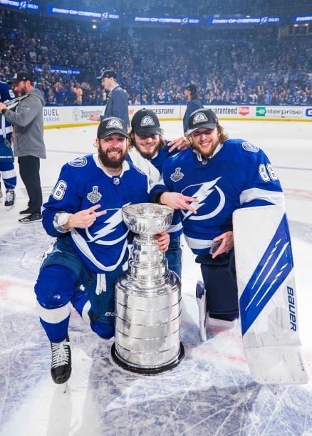 Nikita Kucherov, Mikhail Sergachev, and goalie Andrei Vasilevskiy of the Tampa Bay Lightning celebrates with the Stanley Cup after defeating the...