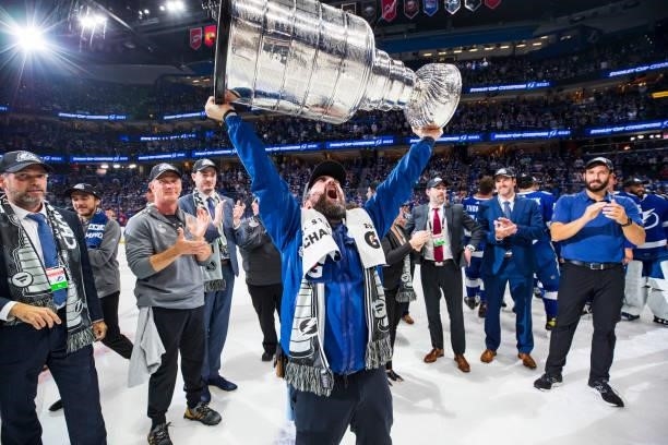 Assistant Equipment Manager Jason Berger of the Tampa Bay Lightning hoists the Stanley Cup overhead after the Tampa Bay Lightning defeated the...