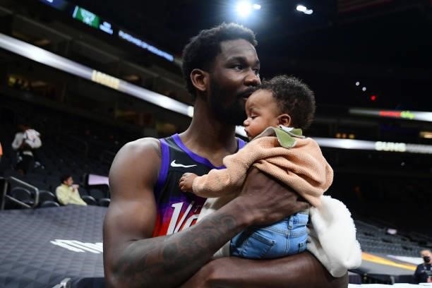 Deandre Ayton of the Phoenix Suns kisses his daughter after the game against the Milwaukee Bucks during Game Two of the 2021 NBA Finals on July 8,...