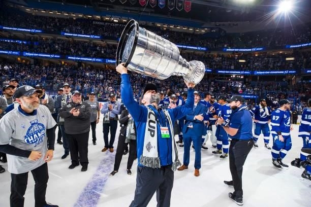 Massage Therapist Christian Rivas of the Tampa Bay Lightning hoists the Stanley Cup overhead after the Tampa Bay Lightning defeated the Montreal...