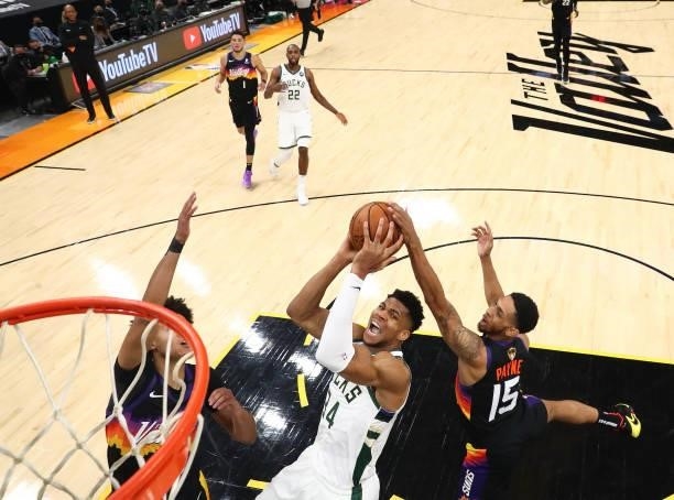 Milwaukee Bucks forward Giannis Antetokounmpo moves in for a basket ahead of Phoenix Suns guard Cameron Payne and forward Cameron Johnson in Game Two...