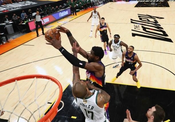Phoenix Suns center Deandre Ayton plays for the ball against Milwaukee Bucks forward P.J. Tucker in Game Two of the NBA Finals at Phoenix Suns Arena...