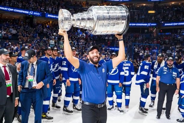 Assistant Strength and Conditioning Coach Brandon Rodgers of the Tampa Bay Lightning hoists the Stanley Cup overhead after the Tampa Bay Lightning...