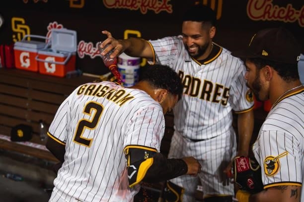 Webster Rivas pours gatorade on Trent Grisham of the San Diego Padres after defeating the Washington Nationals on July 8, 2021 at Petco Park in San...