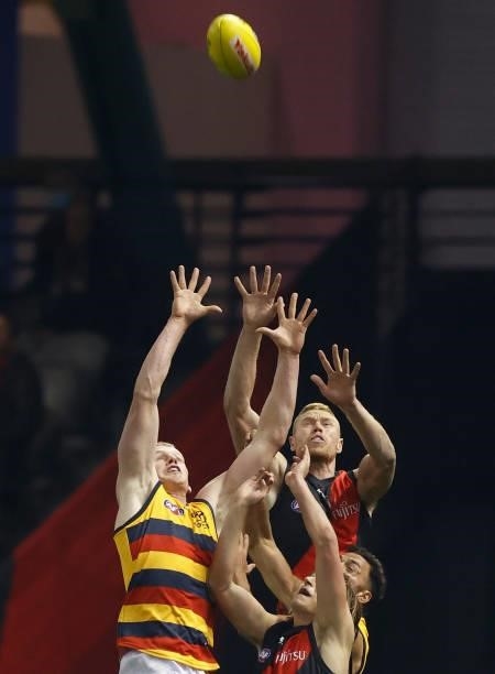 Reilly O'Brien of the Crows and Peter Wright of the Bombers compete for the ball during the 2021 AFL Round 17 match between the Essendon Bombers and...