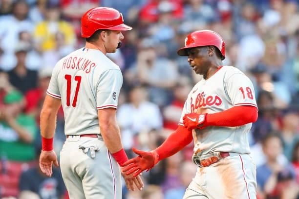 Didi Gregorius high fives Rhys Hoskins of the Philadelphia Phillies after scoring in the second dining of a game against the Boston Red Sox at Fenway...