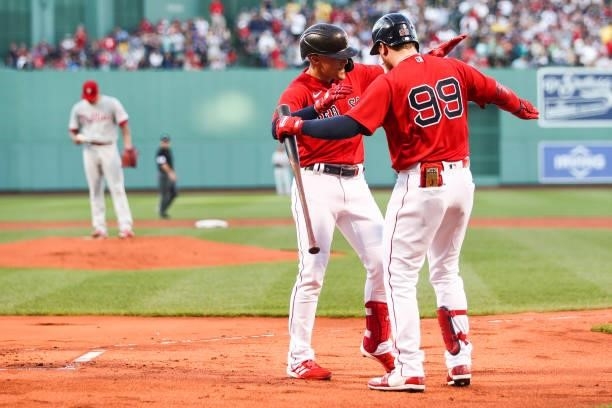 Enrique Hernandez reacts with Alex Verdugo of the Boston Red Sox after hitting a solo home run in the first inning of a game against the Philadelphia...