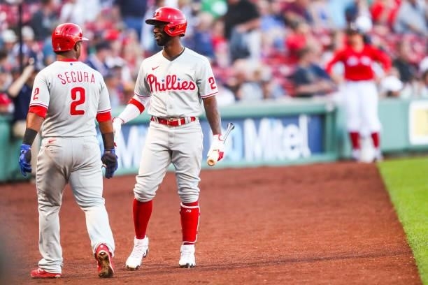 Jean Segura reacts with Andrew McCutchen of the Philadelphia Phillies after scoring in the first inning of a game against the Boston Red Sox at...