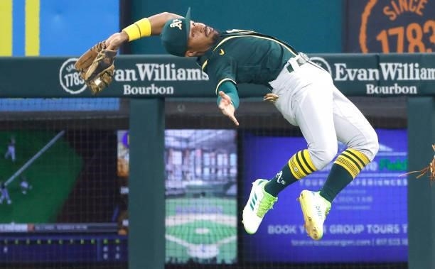 Tony Kemp of the Oakland Athletics makes a backward, leaping catch for an out off the bat of Isiah Kiner-Falefa of the Texas Rangers during the first...