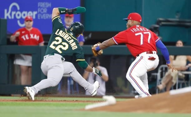 Ramon Laureano of the Oakland Athletics is tagged for out by Andy Ibanez of the Texas Rangers after being caught off first base during the first...