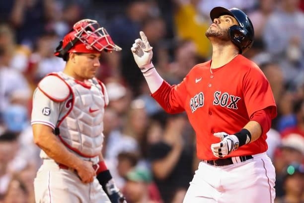 Martinez of the Boston Red Sox reacts as he crosses home plate after hitting a three-run home run as J.T. Realmuto of the Philadelphia Phillies looks...