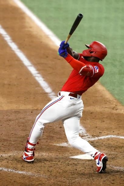 Adolis Garcia of the Texas Rangers singles and drives in two runs against the Oakland Athletics during the sixth inning at Globe Life Field on July...