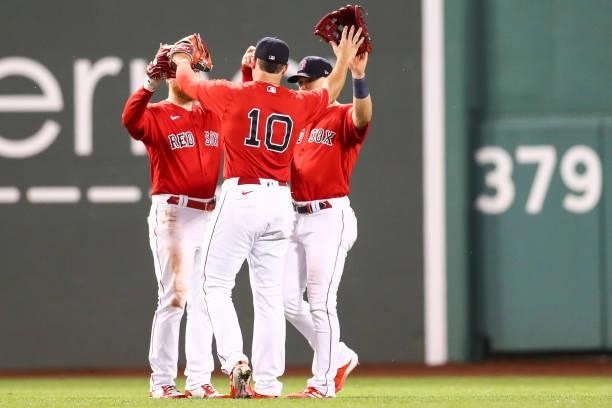 Alex Verdugo, Hunter Renfroe, and Enrique Hernandez of the Boston Red Sox react after a victory over the Philadelphia Phillies at Fenway Park on July...