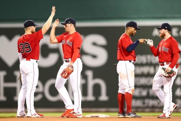 The Boston Red Sox high five each other after a victory over the Philadelphia Phillies at Fenway Park on July 9, 2021 in Boston, Massachusetts.