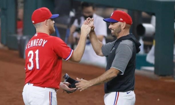 Ian Kennedy of the Texas Rangers and manager Chris Woodward celebrate the teams 3-2 win over the Oakland Athletics at Globe Life Field on July 9,...