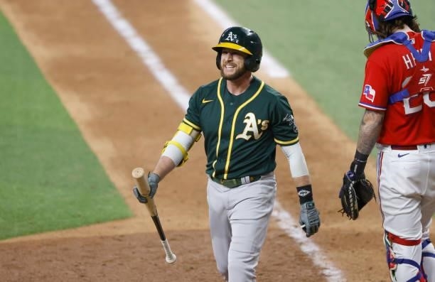 Jed Lowrie of the Oakland Athletics reacts after striking out against the Texas Rangers during the eighth inning at Globe Life Field on July 9, 2021...