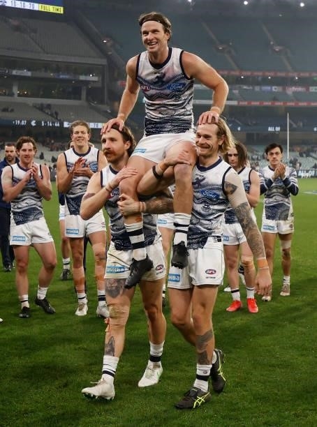 Lachie Henderson of the Cats is chaired from the field after his 200th match by teammates Zach Tuohy and Tom Stewart during the 2021 AFL Round 17...