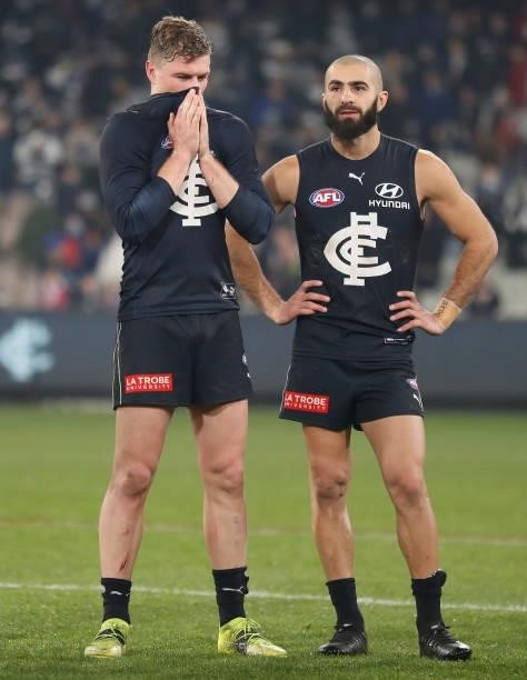 Jack Newnes and Adam Saad of the Blues look dejected after a loss during the 2021 AFL Round 17 match between the Carlton Blues and the Geelong Cats...