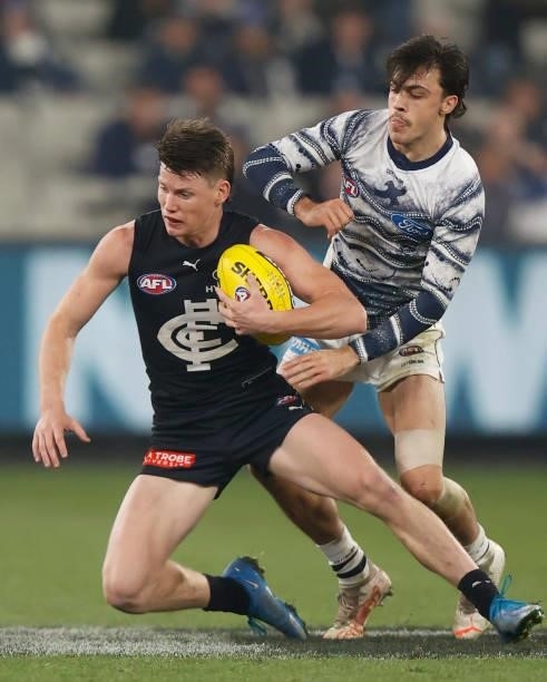 Sam Walsh of the Blues and Brad Close of the Cats compete for the ball during the 2021 AFL Round 17 match between the Carlton Blues and the Geelong...