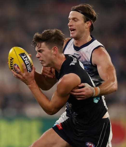 Paddy Dow of the Blues and Lachie Henderson of the Cats compete for the ballduring the 2021 AFL Round 17 match between the Carlton Blues and the...