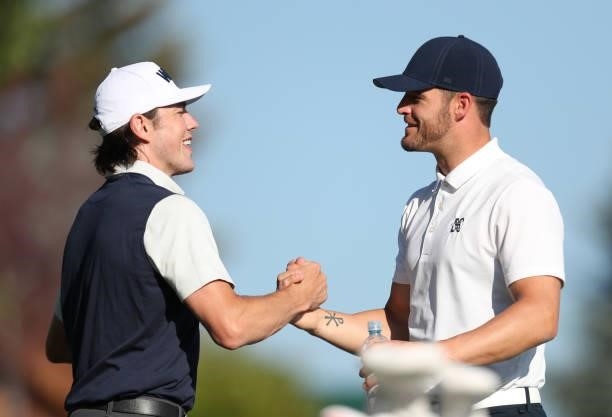 Athlete T.J. Oshie shakes hands with NFL athlete Derek Carr on the first hole during round two of the American Century Championship at Edgewood Tahoe...