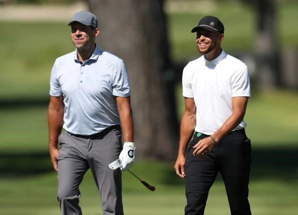 Athlete Steph Curry and former NFL athlete Tony Romo walk up the second hole during round two of the American Century Championship at Edgewood Tahoe...
