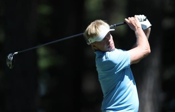 Actor Jack Wagner tees off on the fourth hole of the American Century Championship at Edgewood Tahoe South golf course on July 10, 2020 in South Lake...