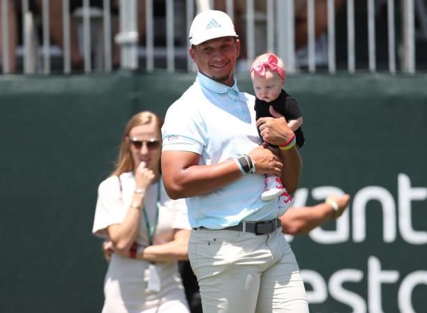 Athlete Patrick Mahomes holds his daughter on the 17th hole during round two of the American Century Championship at Edgewood Tahoe South golf course...