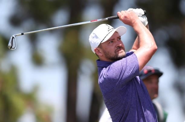 Musician Justin Timberlake tees off on the 17th hole during round two of the American Century Championship at Edgewood Tahoe South golf course on...