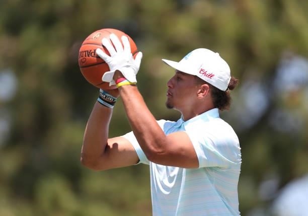 Athlete Patrick Mahomes shoots a basketball on the 17th hole during round two of the American Century Championship at Edgewood Tahoe South golf...