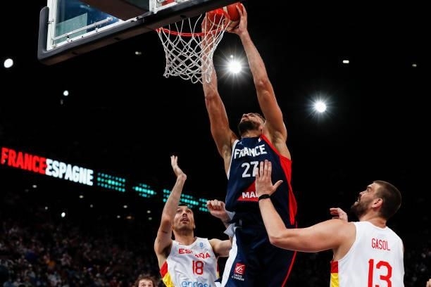 Rudy Gobert of France is at the basket against Pierre Oriola of Spain and Marc Gasol of Spain during the preparation for Olympic Games basketball...