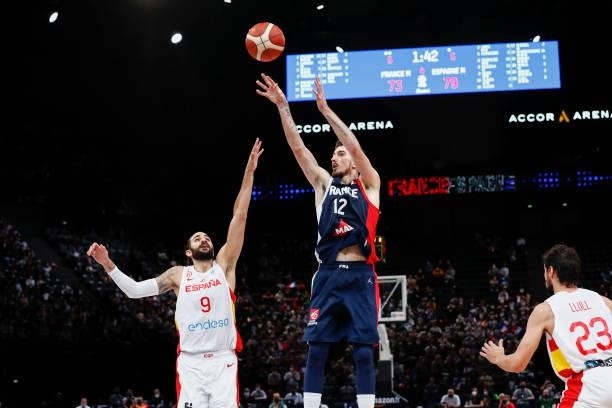 Nando De Colo of France shoots a three points against Ricky Rubio of Spain during the preparation for Olympic Games basketball match between France...
