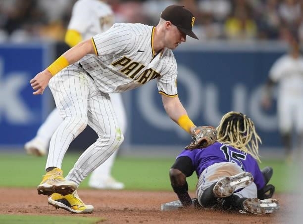 Raimel Tapia of the Colorado Rockies steals second base ahead of the tag of Jake Cronenworth of the San Diego Padres during the third inning of a...