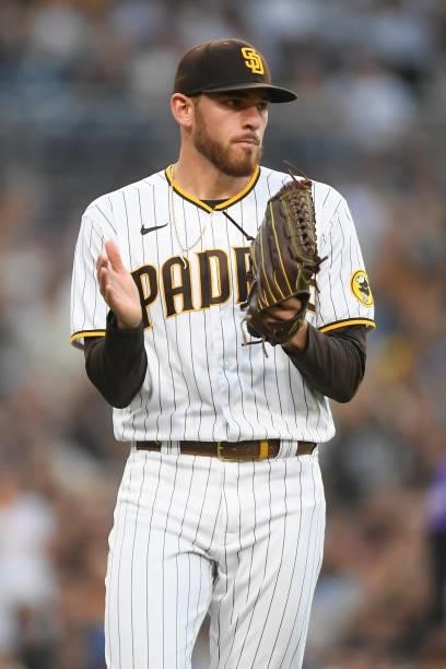 Joe Musgrove of the San Diego Padres claps after a fielding play by Jake Cronenworth during the first inning of a baseball game against the Colorado...