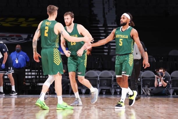 Nathan Sobey of the Australia Men's National Team high fives Patty Mills of the Australia Men's National Team during the game against the Argentina...