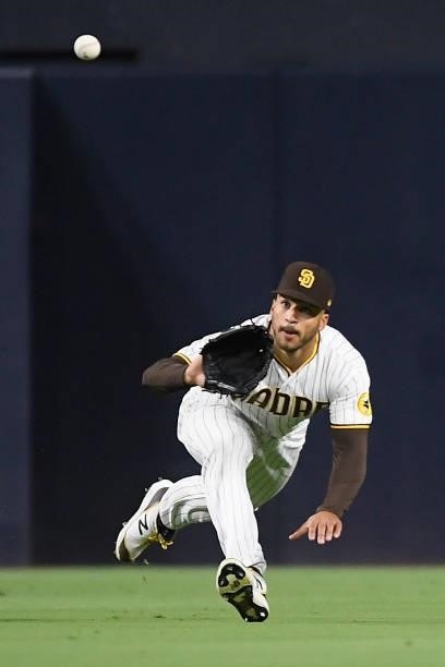 Trent Grisham of the San Diego Padres makes a diving catch on a ball hit by Dom Nunez of the Colorado Rockies during the sixth inning of a baseball...