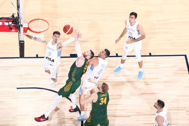 Nicolas Brussino, Aron Baynes of the Australia Men's National Team fight for the rebound during the game on July 10, 2021 at Michelob ULTRA Arena in...