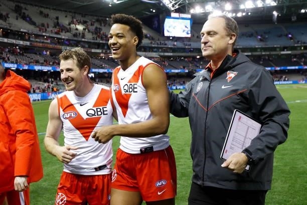 Harry Cunningham, Joel Amartey and senior coach John Longmire of the Swans celebrate during the 2021 AFL Round 17 match between the Western Bulldogs...