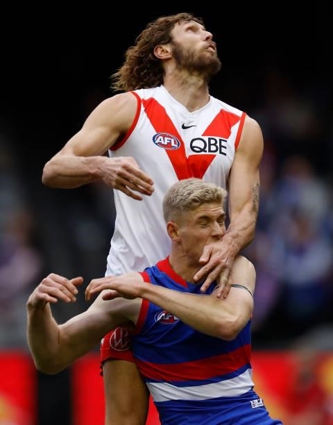 Tim English of the Bulldogs is taken high by Tom Hickey of the Swans during the 2021 AFL Round 17 match between the Western Bulldogs and the Sydney...