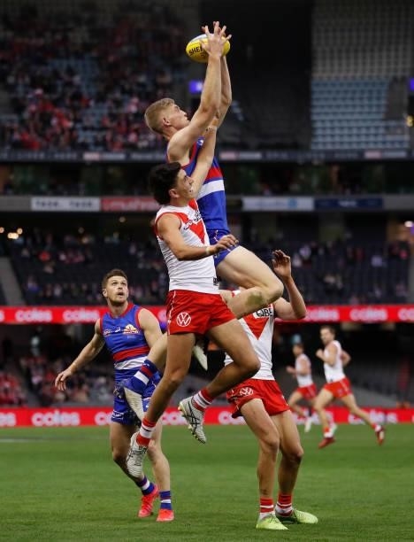 Tim English of the Bulldogs marks the ball over Justin McInerney of the Swans during the 2021 AFL Round 17 match between the Western Bulldogs and the...