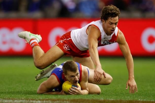 Oliver Florent of the Swans and Jack Macrae of the Bulldogs in action during the 2021 AFL Round 17 match between the Western Bulldogs and the Sydney...