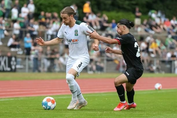 Michael Lang of Borussia Moenchengladbach and Youssef Amyn of Viktoria Koeln battle for the Ball during the Pre-Season Match between Borussia...