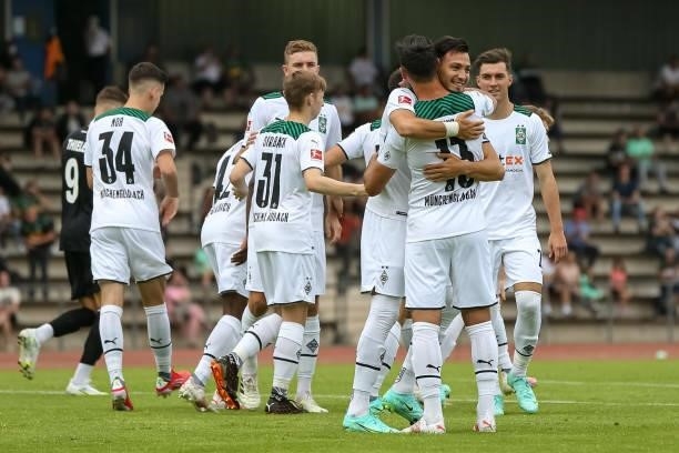 Ramy Bensebaini of Borussia Moenchengladbach celebrates after scoring his team's first goal with teammates during the Pre-Season Match between...