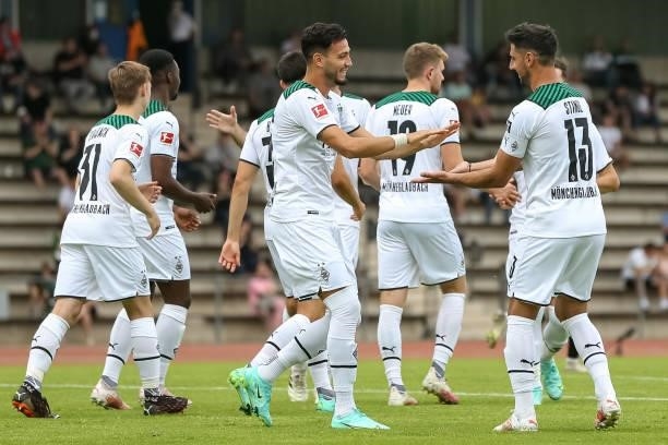 Ramy Bensebaini of Borussia Moenchengladbach celebrates after scoring his team's first goal with teammates during the Pre-Season Match between...