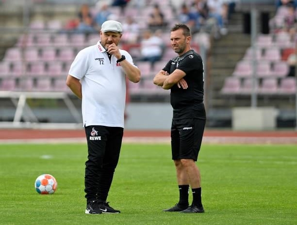 Head coach Steffen Baumgart of 1. FC Koeln and assistant coach Andre Pawlak of 1. FC Koeln look on during the Pre-Season Friendly match between...