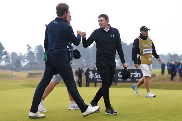 Matthew Fitzpatrick is pictured with Thomas Detry as the tournament goes to a play off during day four of the abrdn Scottish Open at the Renaissance...