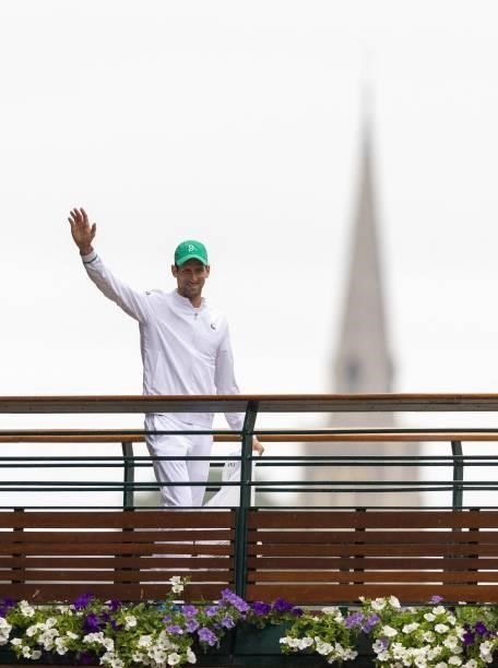 Serbia's Novak Djokovic waves to the crowds as he walks across the bridge over St Mary's Walk after defeating Italy's Matteo Berrettini during their...